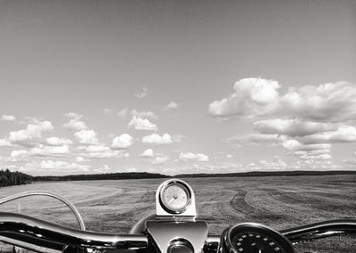 Fine art photographer David Lee Black's Road King Harley Davidson with open field, clouds and sky with the theme of infinite possibility.  